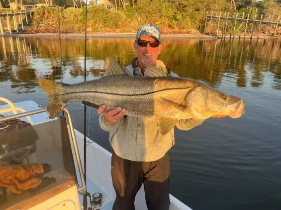 Captain Mark Dravo holding a large Snook